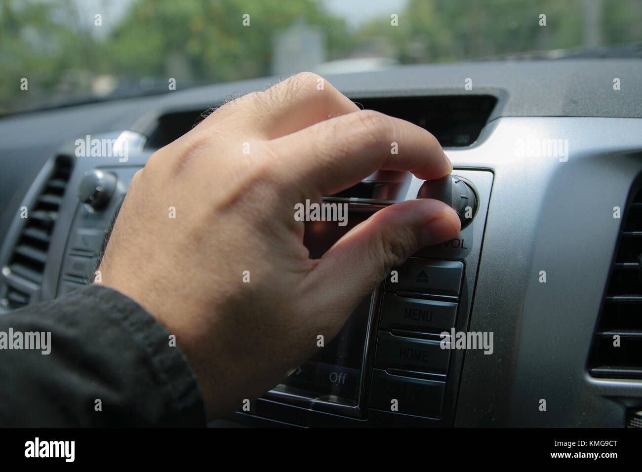 Nahaufnahme der Mann am Schalter zum Öffnen des Radio im Auto. Stockfoto