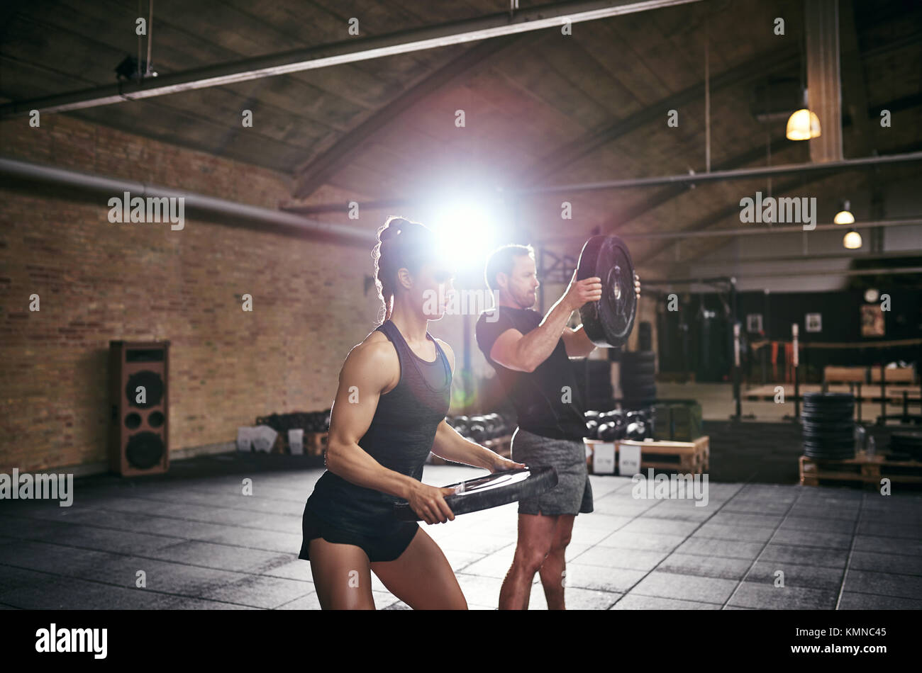 Porträt von zwei Junge muskulöse Sportler Training im Fitnessraum und Gewichte zu heben. Stockfoto