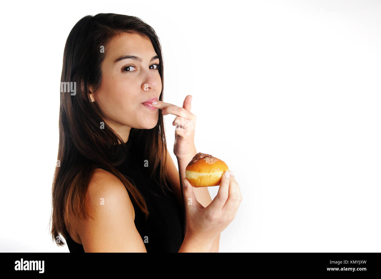 Essen süßes Donut (Sufganiyah) eine traditionelle jüdische Donut während Chanukka gegessen, mit viel Freude und Kalorien Stockfoto