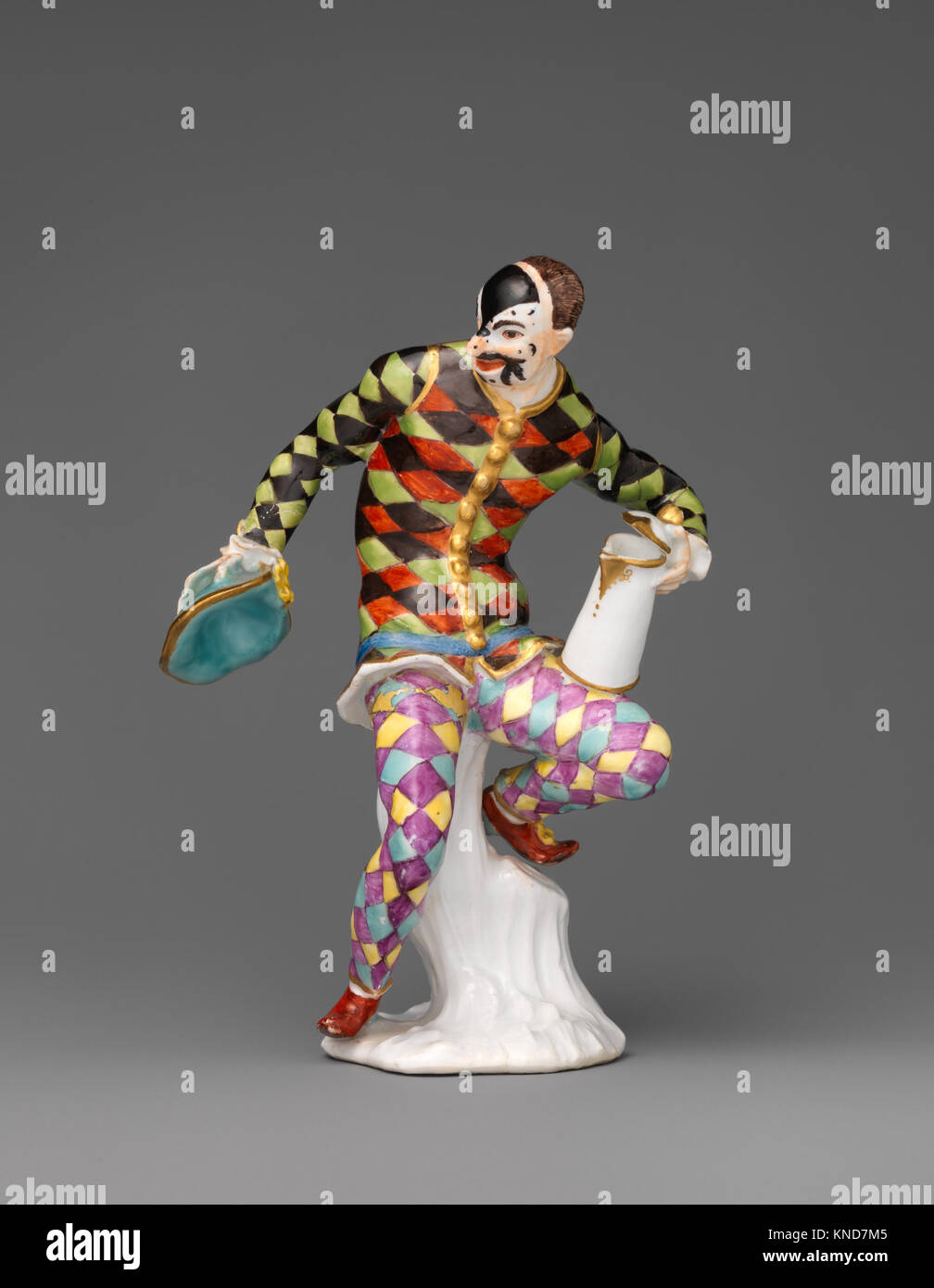 Diese Meissener Porzellan-Harlequin-Figur aus dem 18. Jahrhundert, nach dem Vorbild von Johann Joachim Kändler, spiegelt die feine Handwerkskunst und den theatralischen Charakter des Harlequin im europäischen Theater wider, das Teil der MET-Sammlung ist. Stockfoto