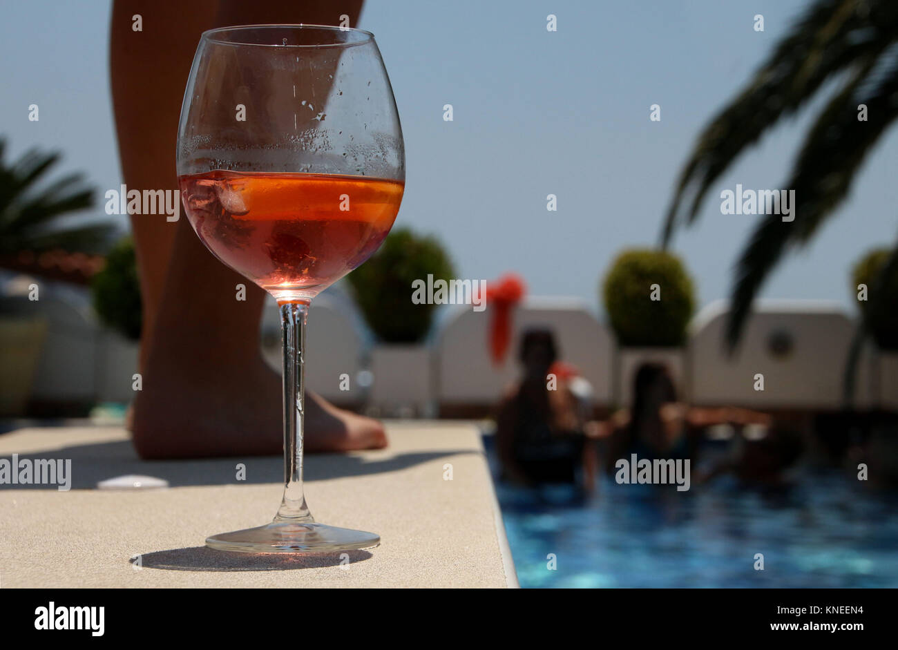 Glas Rose Wein durch den Rand eines Schwimmbad an einem Pool Party Stockfoto