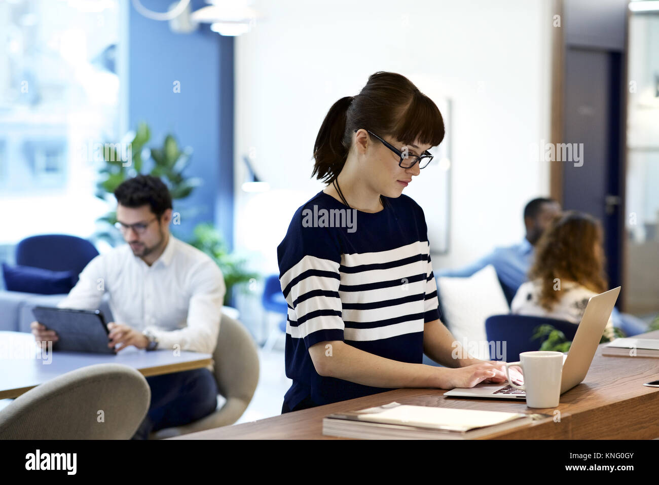 Kaukasische weiblichen Geschäftsfrau, tragen, Brille, der an einem Notebook arbeitet in einem modernen Büro Stockfoto