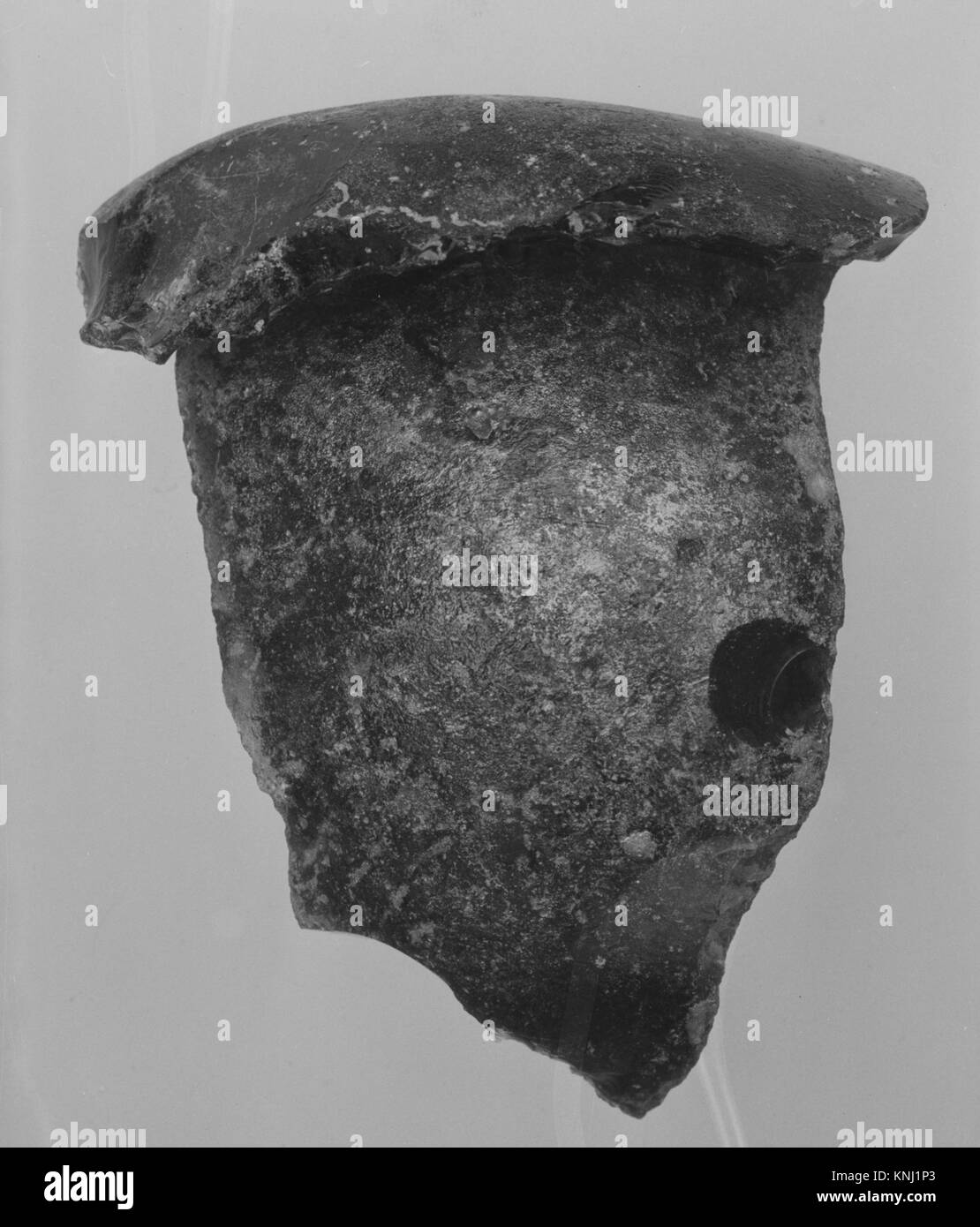 Ein amerikanisches Flaschenfragment aus dem 18. Jahrhundert aus frei geblasenem, bleifreiem Glas, das frühe Glasmachertechniken und historische Handwerkskunst widerspiegelt. Stockfoto