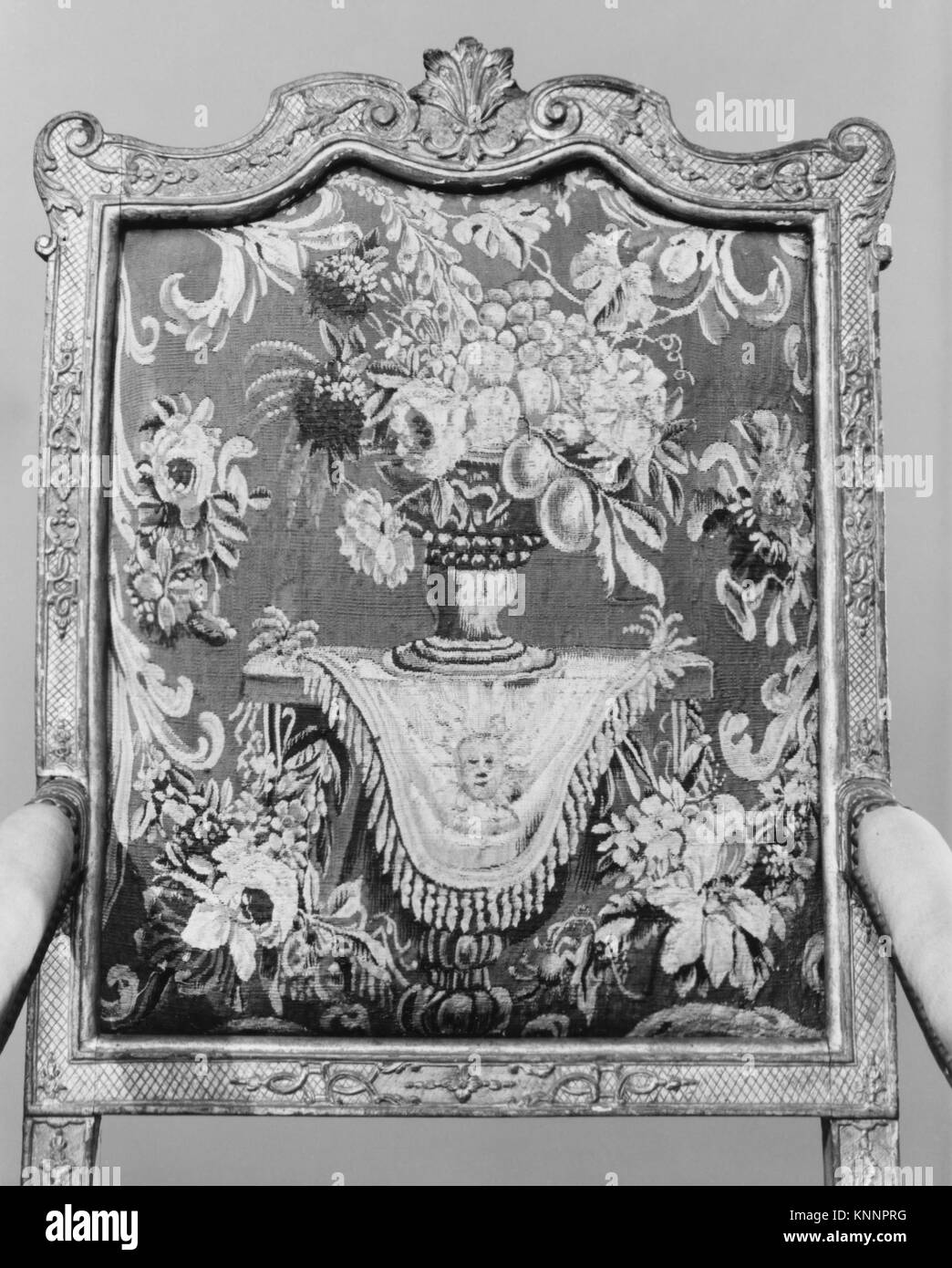 Ein französischer Sessel (Fauteuil) aus dem ersten Viertel des 18. Jahrhunderts, geschnitztes und vergoldetes Buchenholz mit Wollbezügen aus Aubusson, 47 1/2 x 27 1/2 x 21 5/8 cm, Teil der MET-Kollektion, beispielhaft für Möbeldesign und Handwerkskunst der Zeit. Stockfoto