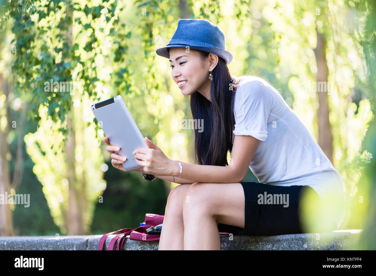 Asiatische Frau mit einem Tablet-PC im Freien Stockfoto