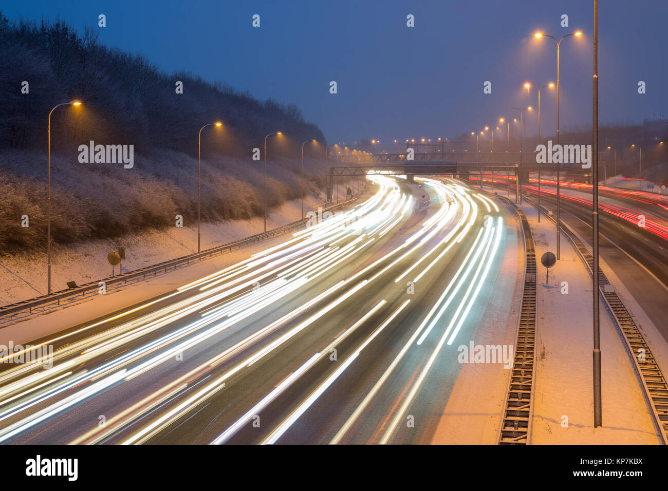 Die Autobahn A27 in den Abend mit Schnee bedeckt in der Nähe der Lunetten Kreuzung mit den Lichtern der Verkehr im Winter. Stockfoto