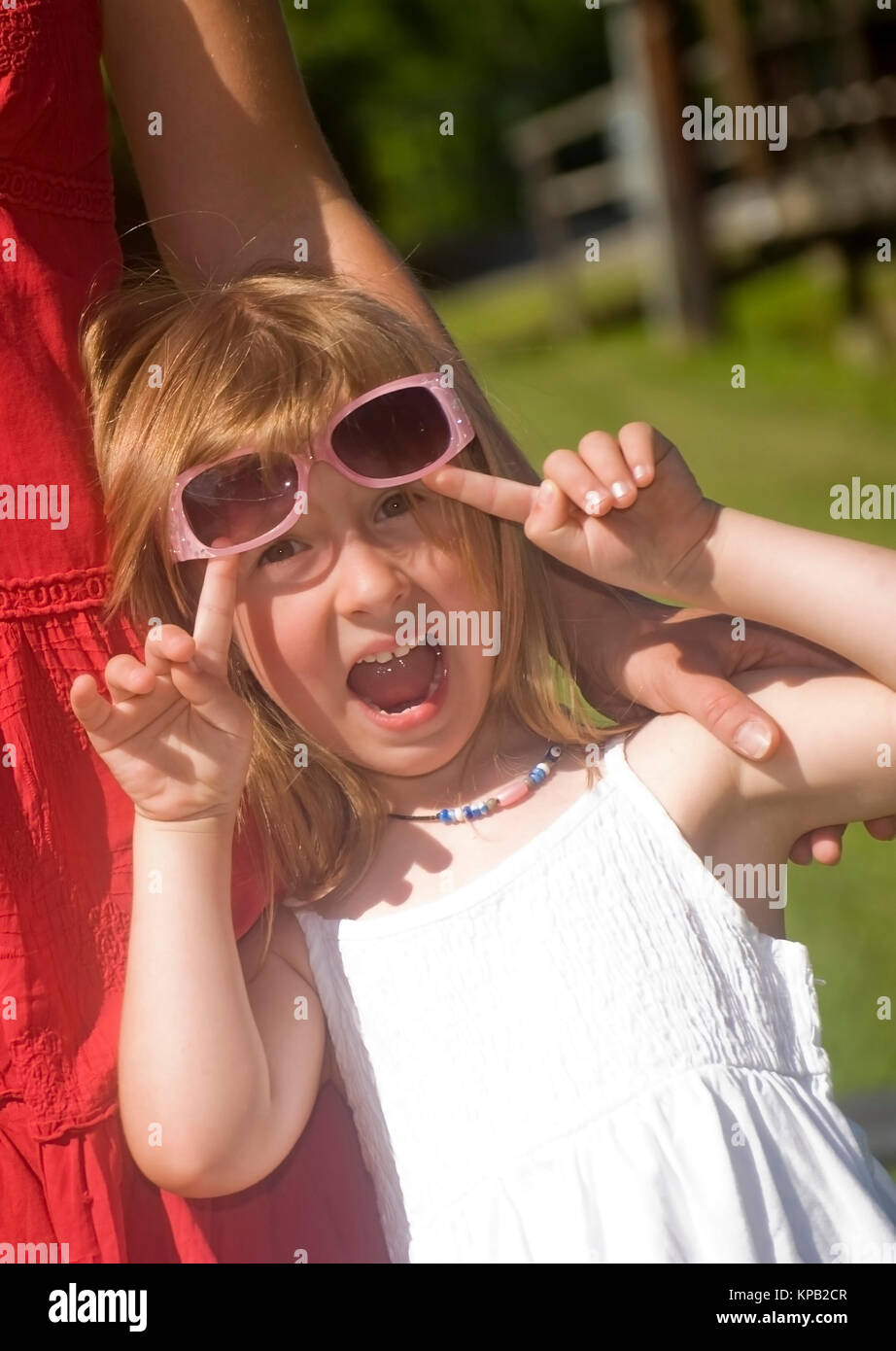 Model Release, Lustiges Maedchen Mit Sonnenbrille - lustiges Mädchen mit Sonnenschirmen Stockfoto