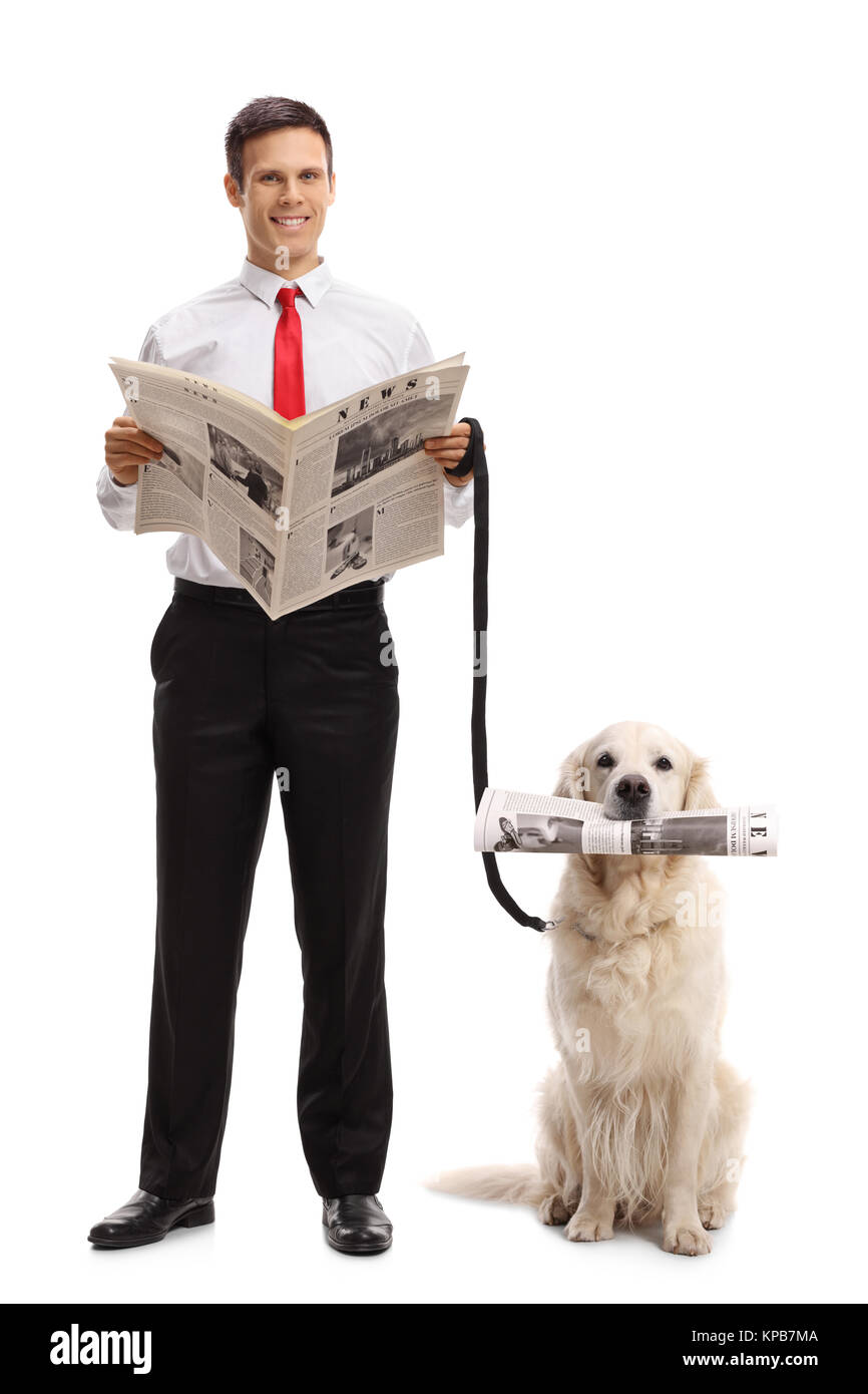 In voller Länge Porträt eines eleganten Typ mit einer Zeitung und einem Labrador Retriever Hund mit einer Zeitung auf weißem Hintergrund Stockfoto