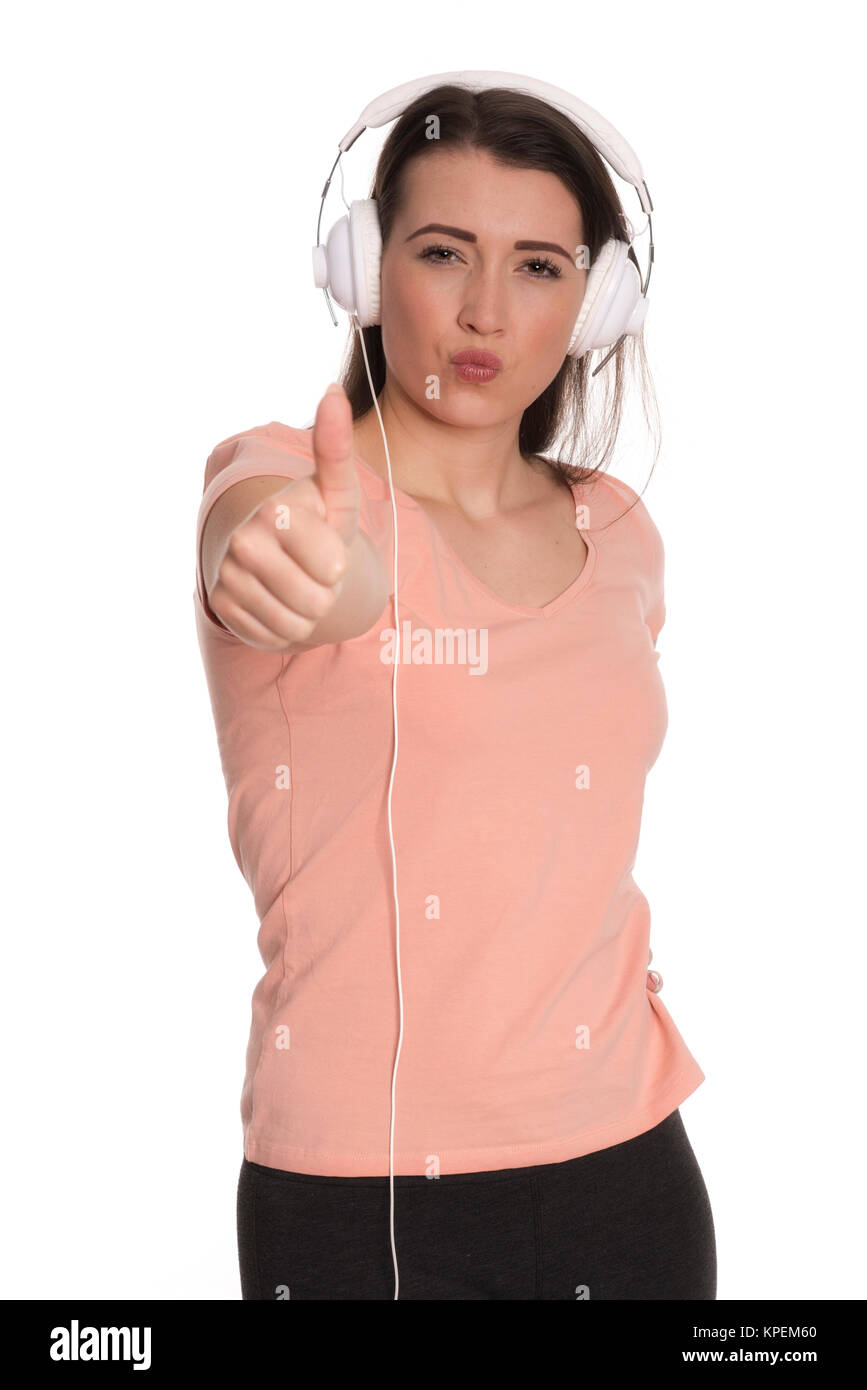 Junge Frau mit Kopfhörer mit Daumen hoch Stockfoto