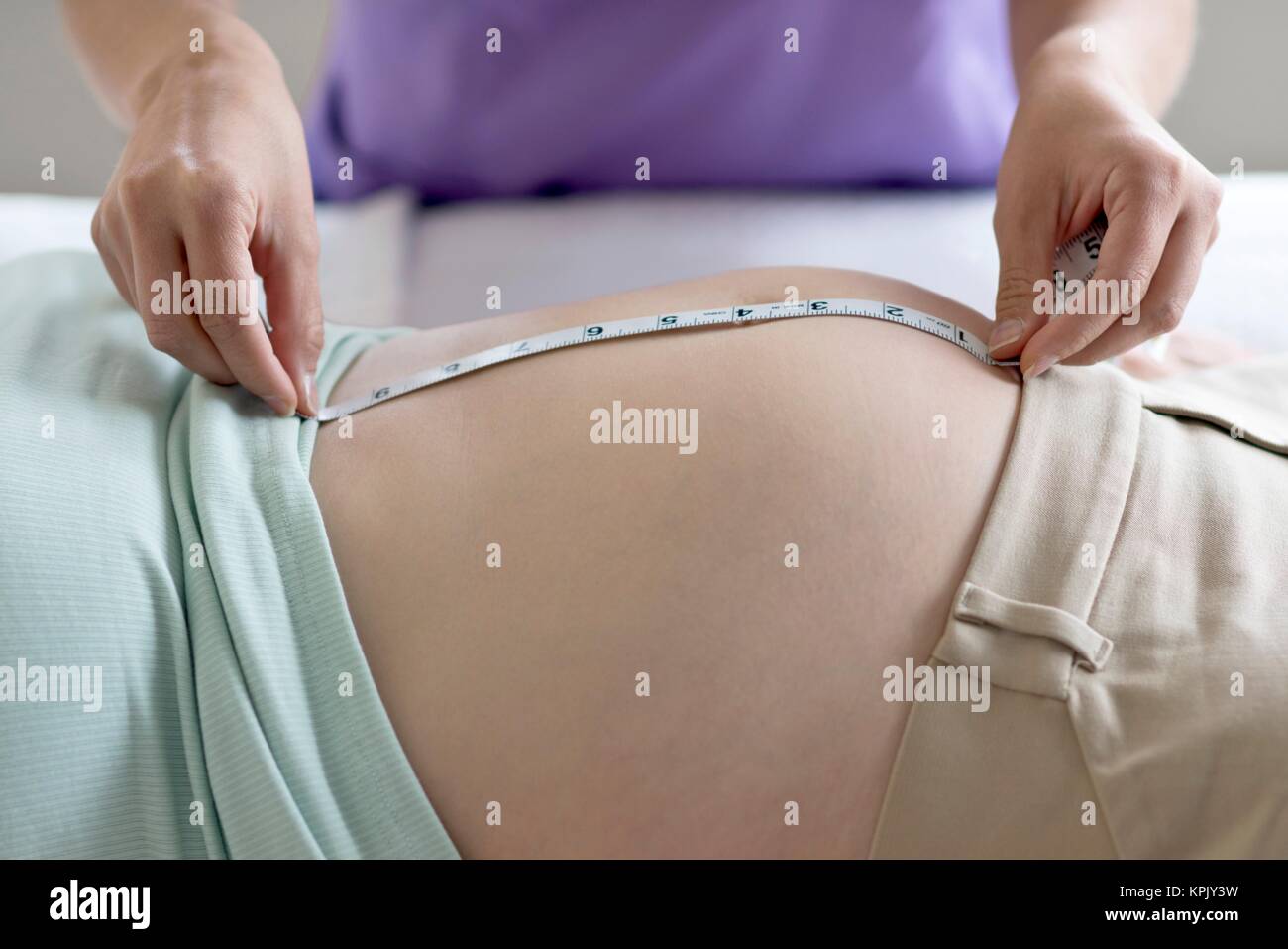Schwangere Frau in Stoß durch Hebamme gemessen. Stockfoto