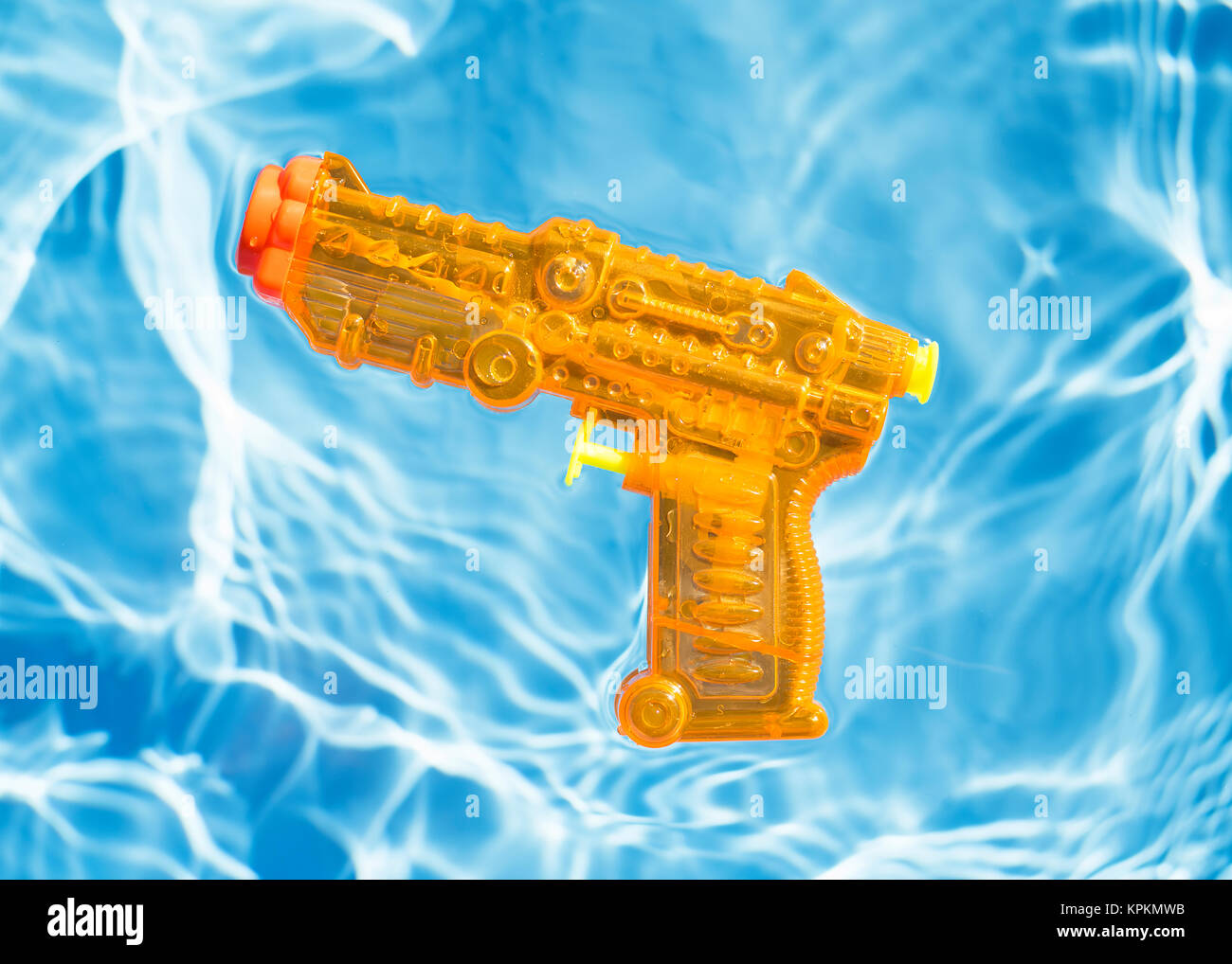 Orange squirt Gun schwimmend im Wasser. Stockfoto
