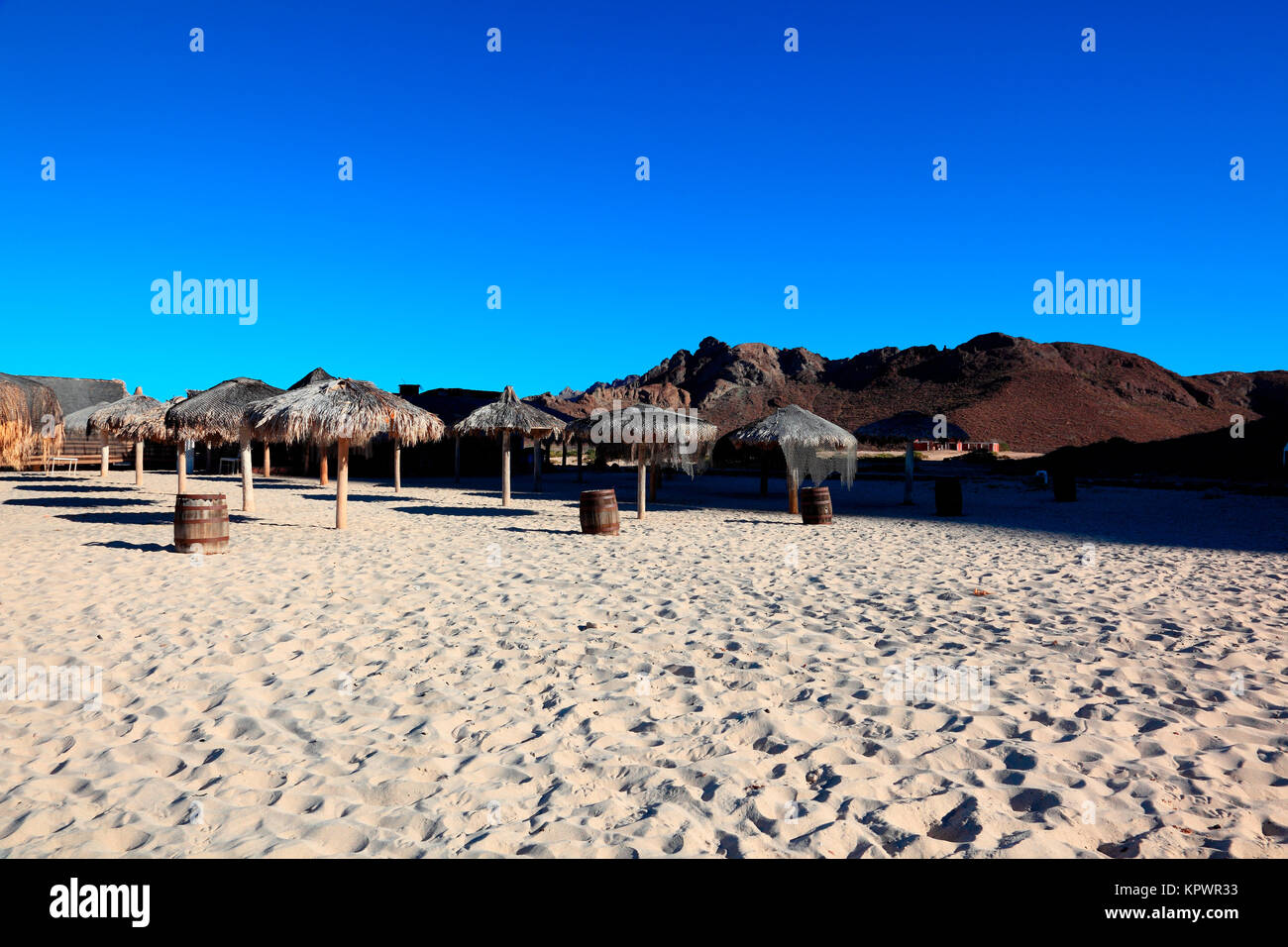 Palapas an einem Sandstrand Stockfoto