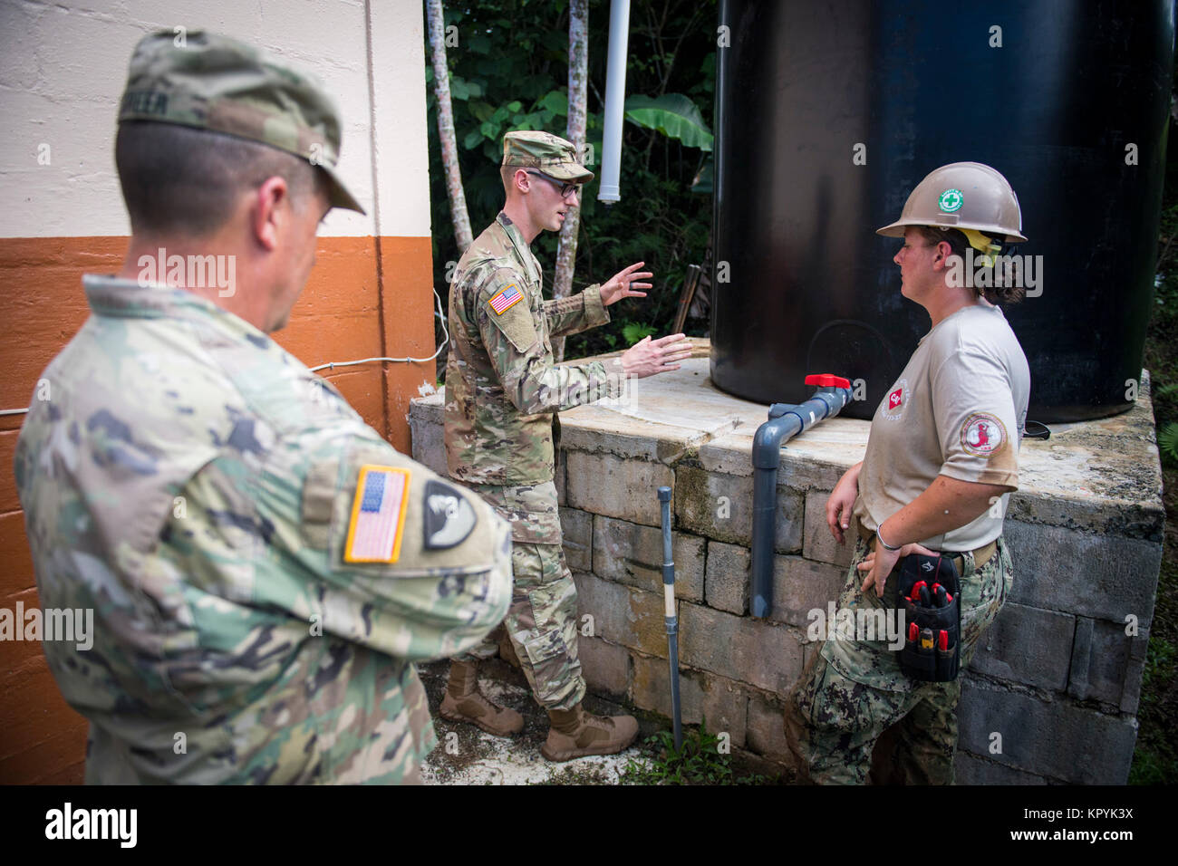 U.S. Navy Utilitiesman 1. Klasse Mariah Stanton, Rechts, zu Naval Mobile Konstruktion Bataillon (NMCB) 133 Civic Action Team (CAT) Palau, unterweist US Army 1st Lieutenant Kevin Hadden, Mitte und US-Armee Sgt zugeordnet. 1. Klasse William Greer, 84th Engineer Battalion zugeordnet, 130 Engineer Brigade, auf der Wasserfassung System ist sie die Installation an der Volksschule in Ibobang Ngeremlengui, Palau, 13. Dezember 2017. NMCB-133 wird bereitgestellt, die expeditionary Bau und Maschinenbau (Combat Service Support) Horizontale und vertikale Ausführung; Instandhaltung und Oper Stockfoto