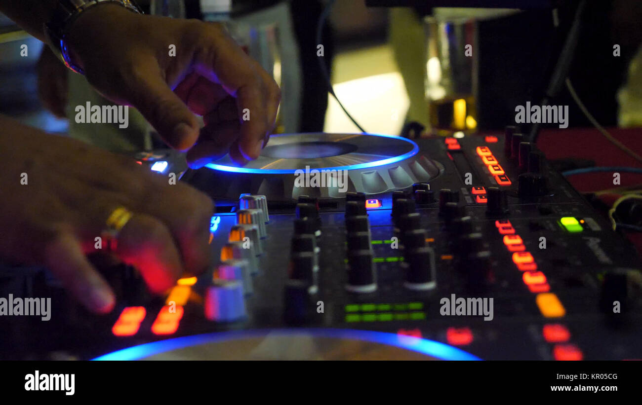 Nahaufnahme von dj Party Musik auf modernen usb cd player in der Disco Club - Nachtleben und Unterhaltung Konzept. DJ-Plattenspieler console Mixer steuern mit zwei Hand in Konzert Nachtclub Stufe Stockfoto