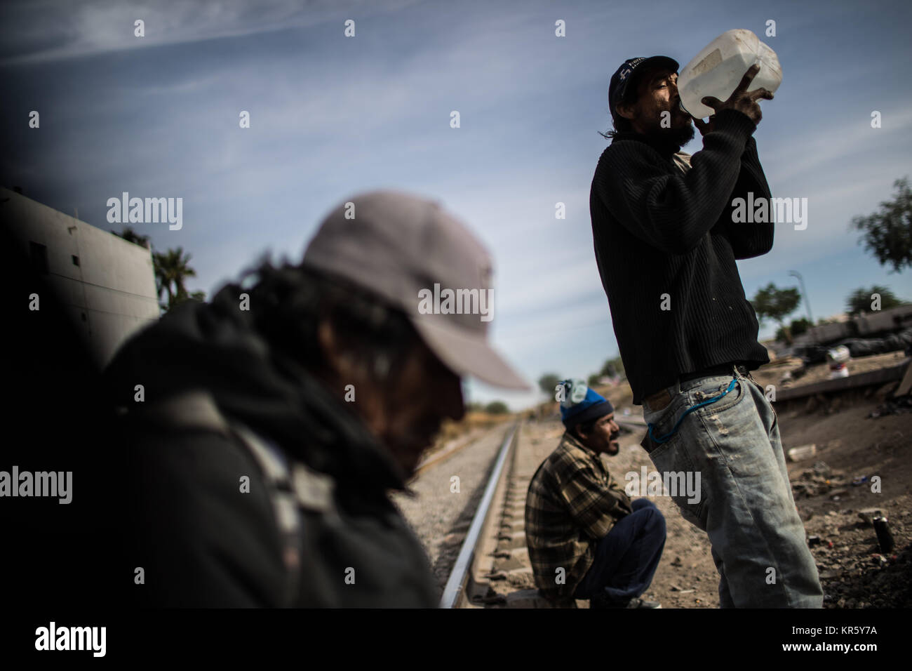 Menschen zwischen Migration, Bedürftigkeit, Marginalisierung, Armut und Drogen gefangen, verbringen ihre Tage auf der Seite der Titel und der Ferromex Stockfoto