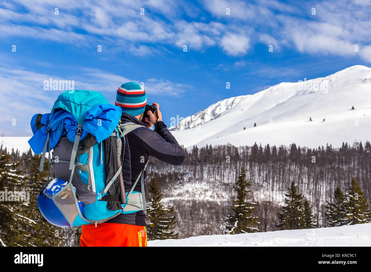 Bla bla Jungen kaukasischen Mann Fotograf Bilder sprechen während backcountry Skiing an einem schönen sonnigen Tag mit frischem Schnee Stockfoto