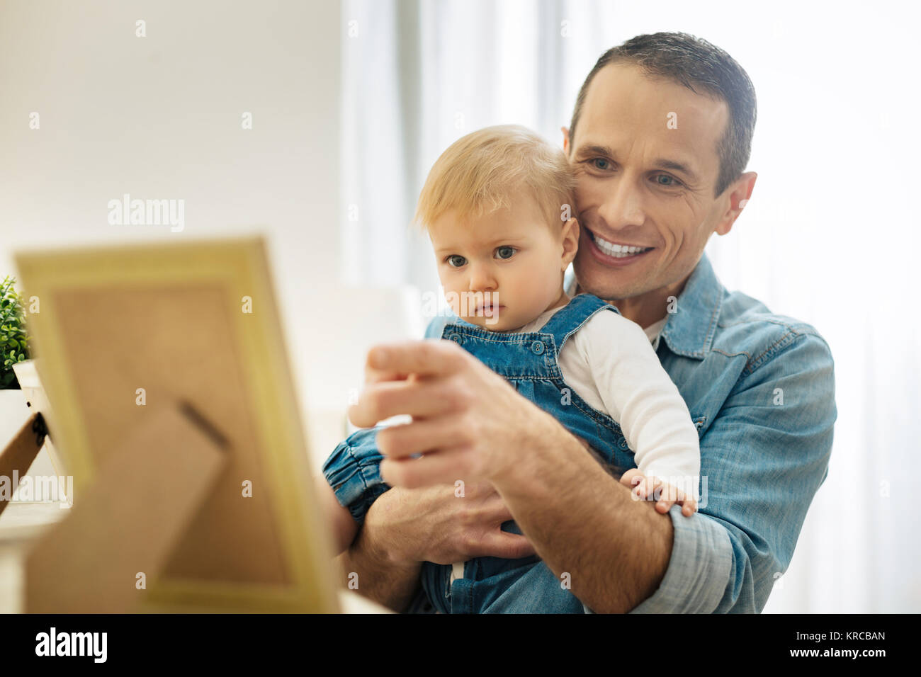 Lächelnd Vater hält ein Baby und verwies auf die schönen Foto Stockfoto
