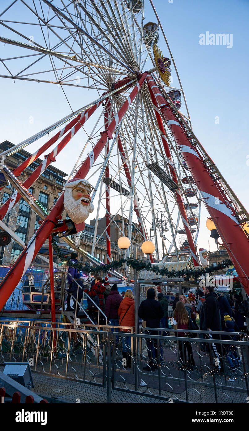 Eine Warteschlange von Menschen wartet auf ein großes Rad setup am George Square in Glasgow, für die Weihnachtszeit. Stockfoto