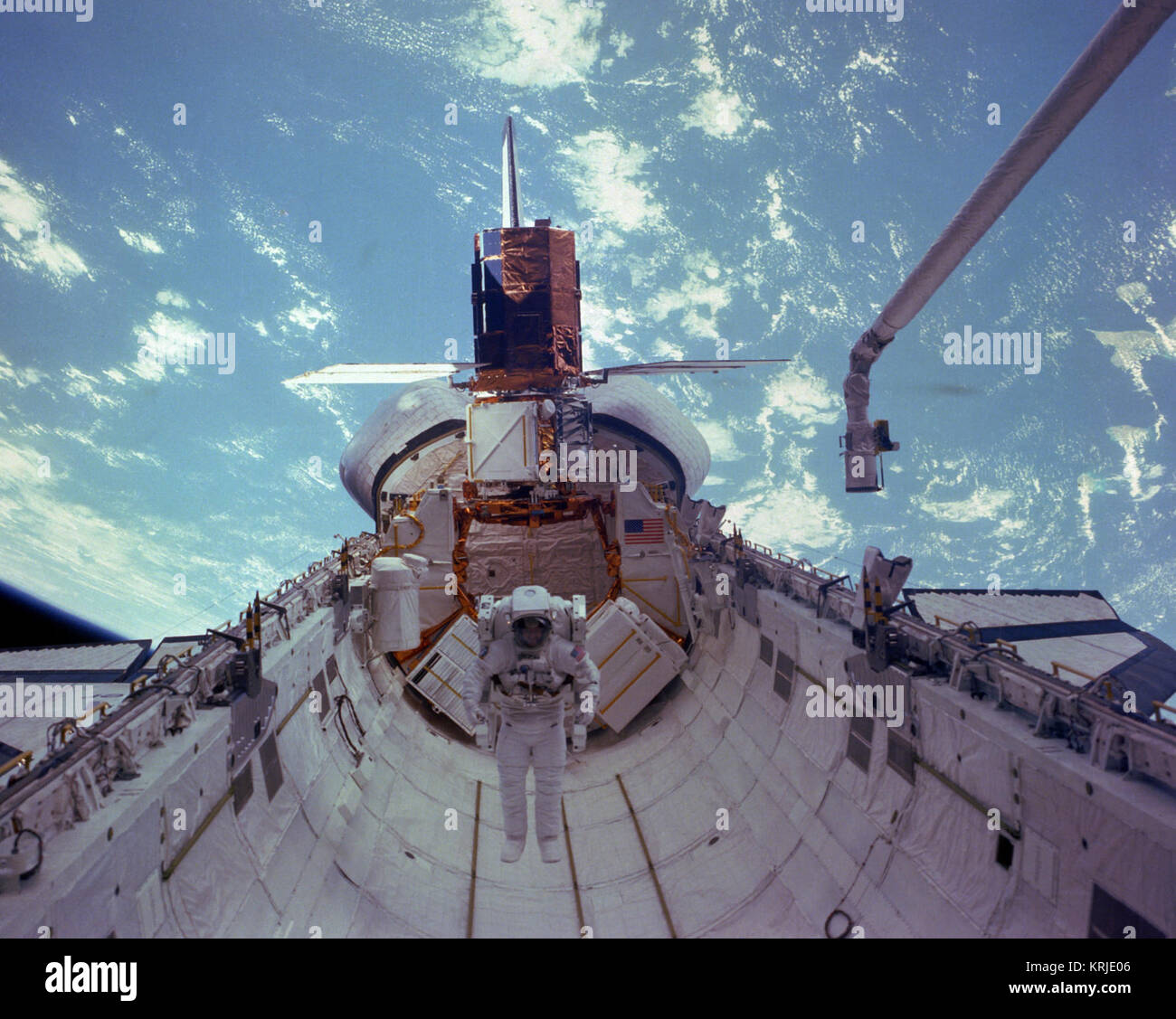 Astronaut James D. van Hoften Tests der bemannten manövrieren Unit (MMU) in die Ladebucht des Space Shuttle Challenger als Teil eines Extra Vehicular Activity (EVA) während des Fluges 41-C. Die Solar Maximum Mission Satelliten (SMMS), repariert und bereit zur Freigabe in den Weltraum, wird an der Flight Support System (FSS) an der Rückseite angeschlossen ist. DF-SC -84-10566 Stockfoto