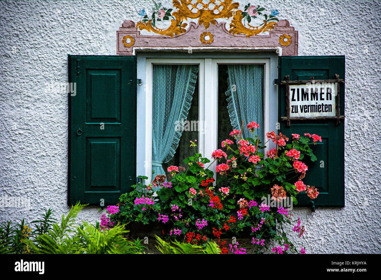 Fenster mit Fensterladen Giachem, Blumen und Schild Zimmer zu vermieten. Stockfoto