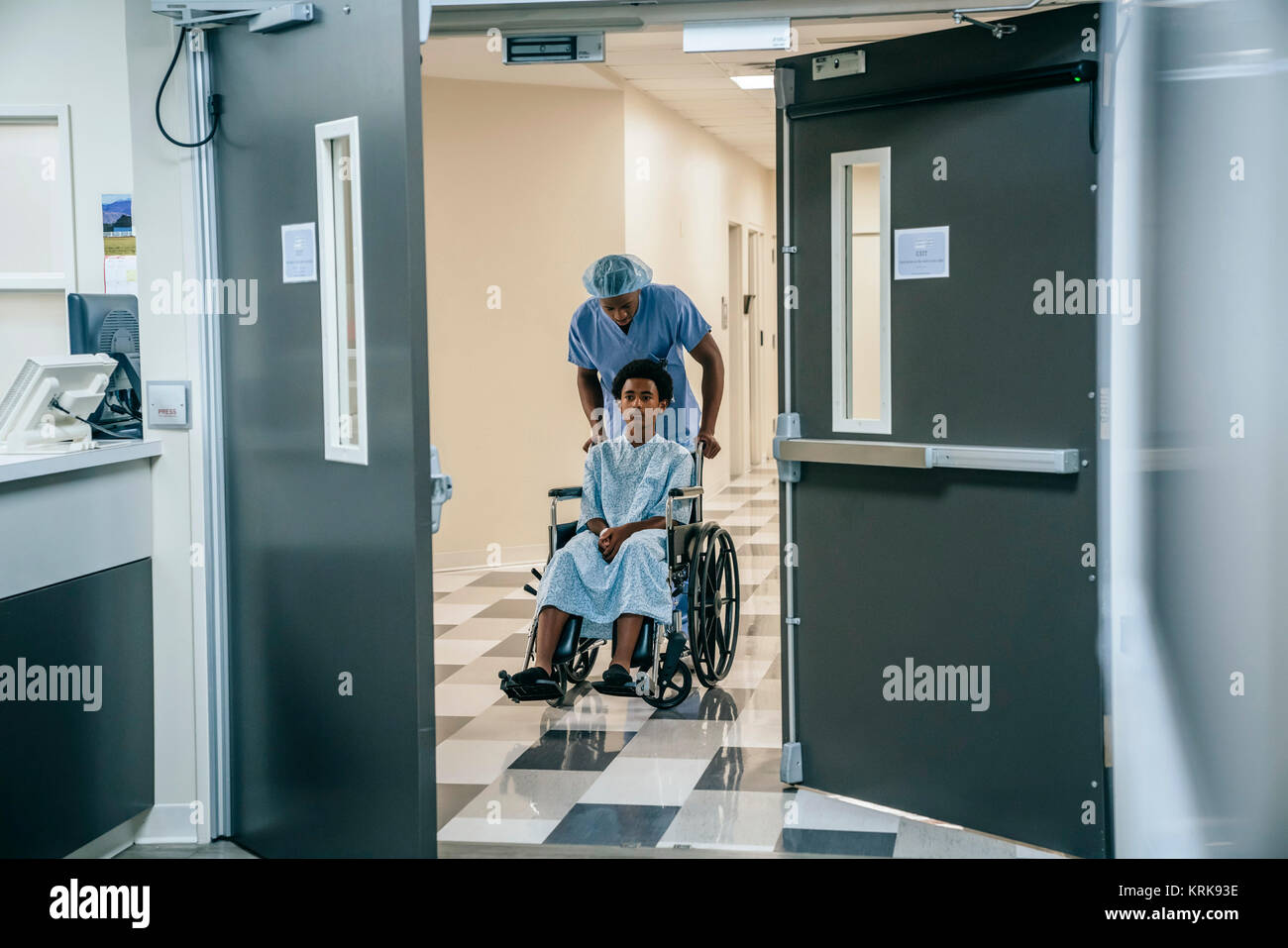Schwarze Krankenschwester schieben Junge im Rollstuhl Stockfoto
