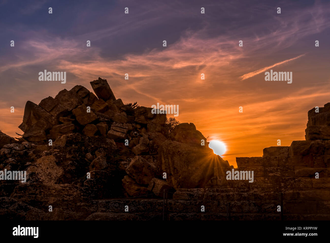 Antike Stadt Ruinen unter Sonnenuntergang mit vereinzelten Wolken Stockfoto