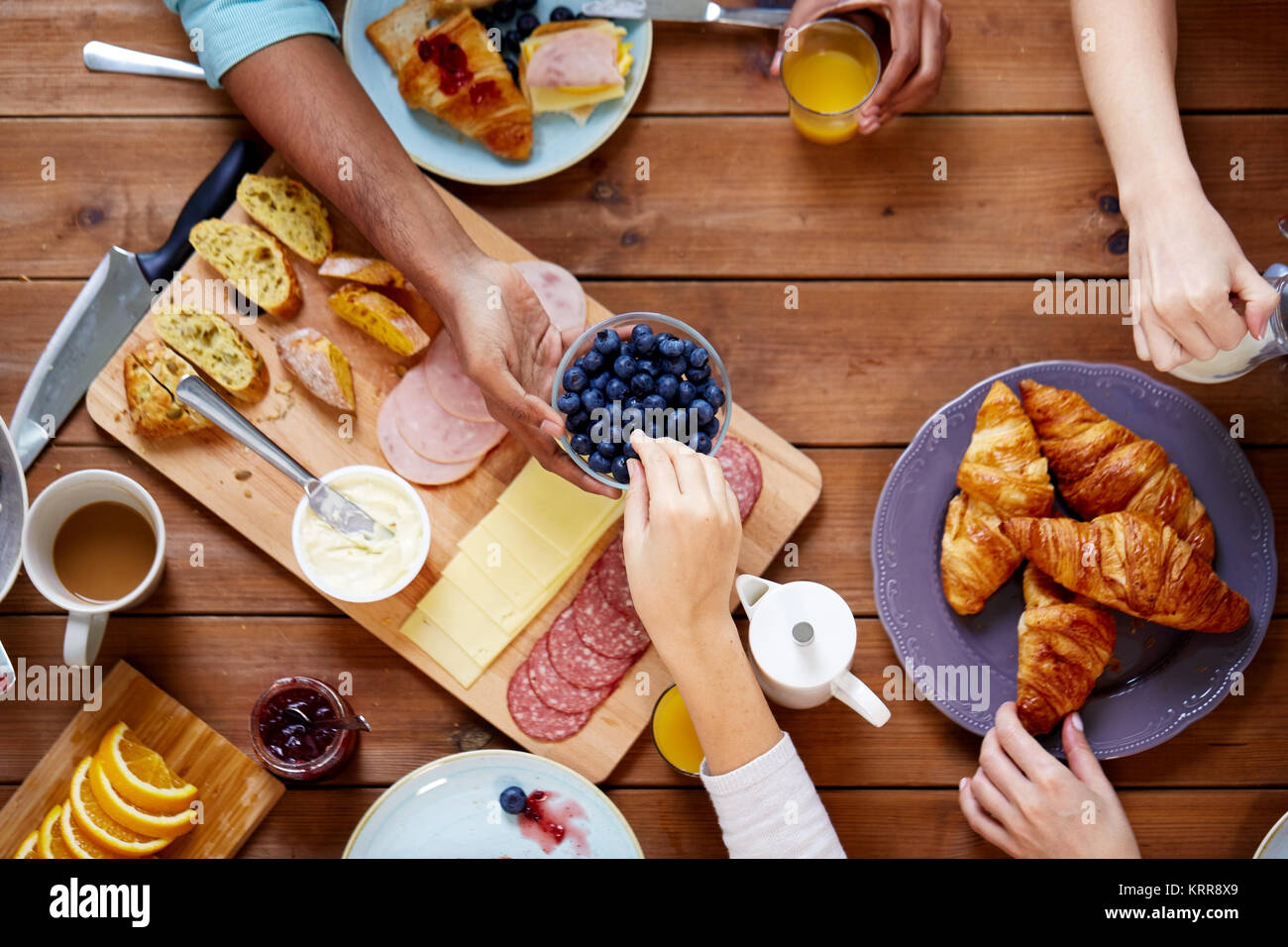Personen mit Frühstück in der Tabelle mit Nahrungsmitteln Stockfoto