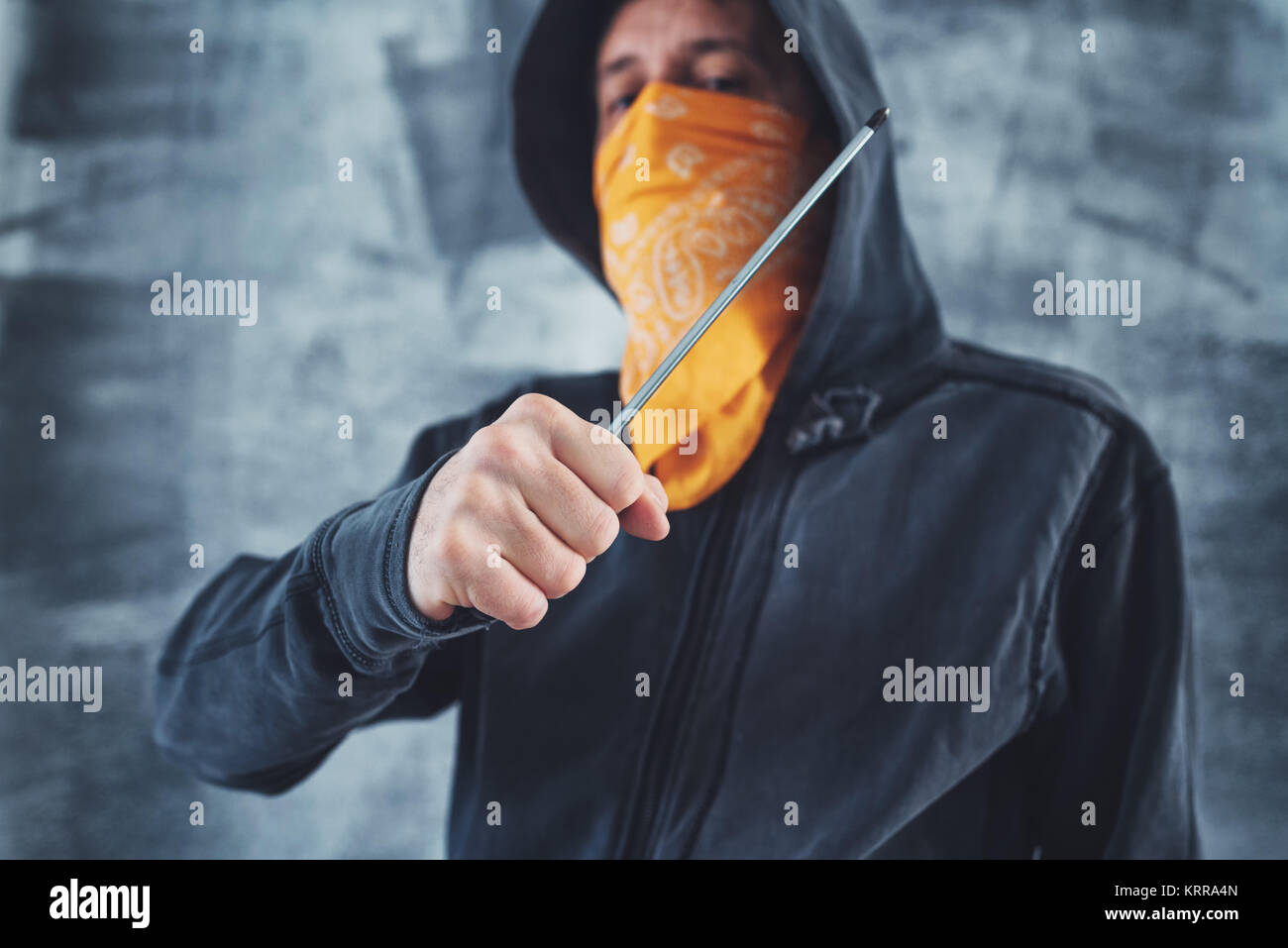 Hooded Bandenmitglieder Kriminelle mit Schal über Gesicht mit Schraubendreher als Waffe Stockfoto