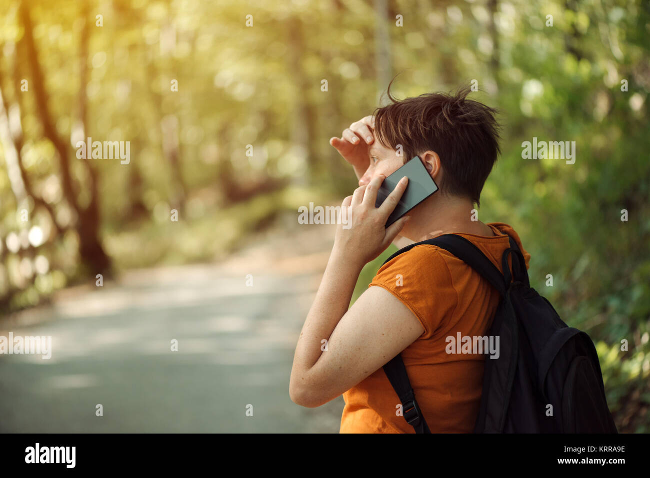 Frau Gespräch am Handy im Park, erwachsene Frau backpacker Walking im Freien und Sie ihr Smartphone für die Kommunikation. Stockfoto