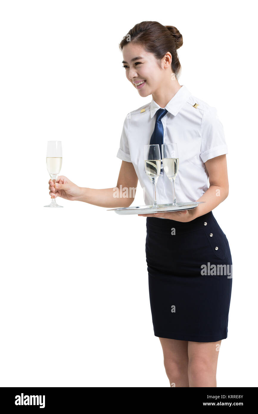Lächelnd Airline Stewardess Champagner servieren Stockfoto