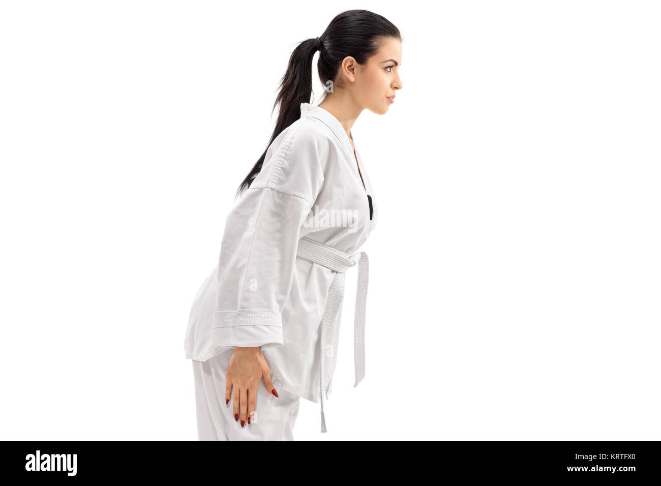 Weibliche Martial Artist Verbeugung auf weißem Hintergrund Stockfoto