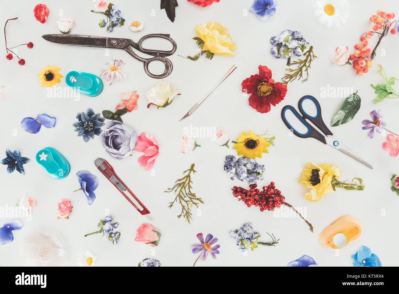 Farbige Blumen mit Schere und feststehenden Messer isoliert auf weißem Stockfoto