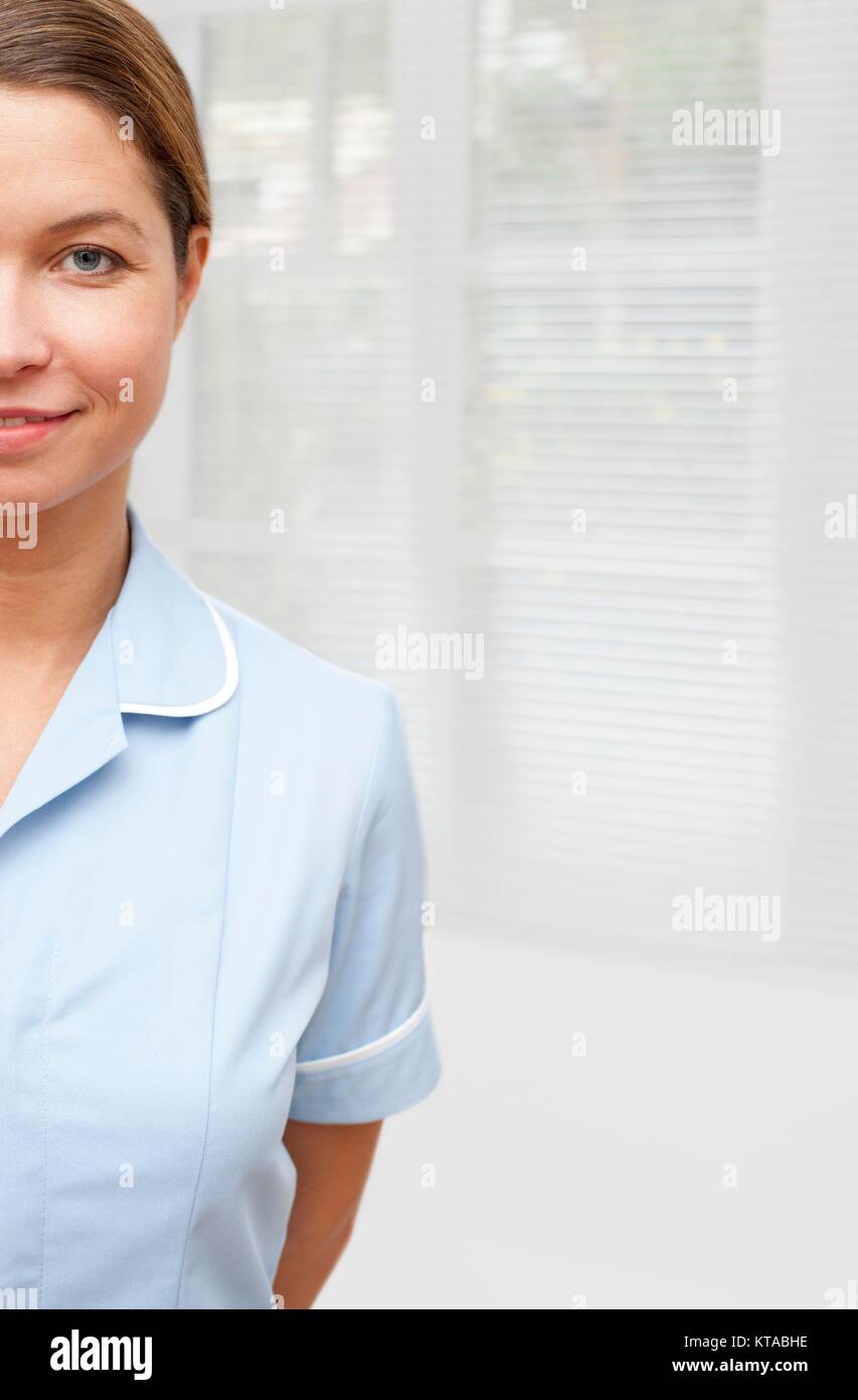 Weibliche Krankenschwester in Uniform Lächeln in Richtung Kamera, 7/8. Stockfoto