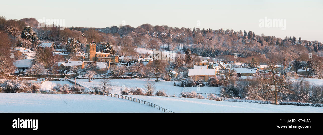 Bourton auf dem Hügel im Schnee bei Sonnenaufgang im Dezember. Bourton auf dem Hügel, Cotswolds, Gloucestershire, England. Panoramablick Stockfoto