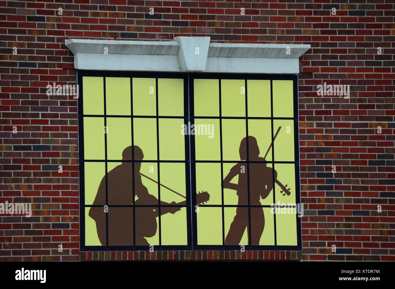 Künstlerische Musiker in einer Music Store Fenster in New Hartford silhouetted, NY, USA Stockfoto