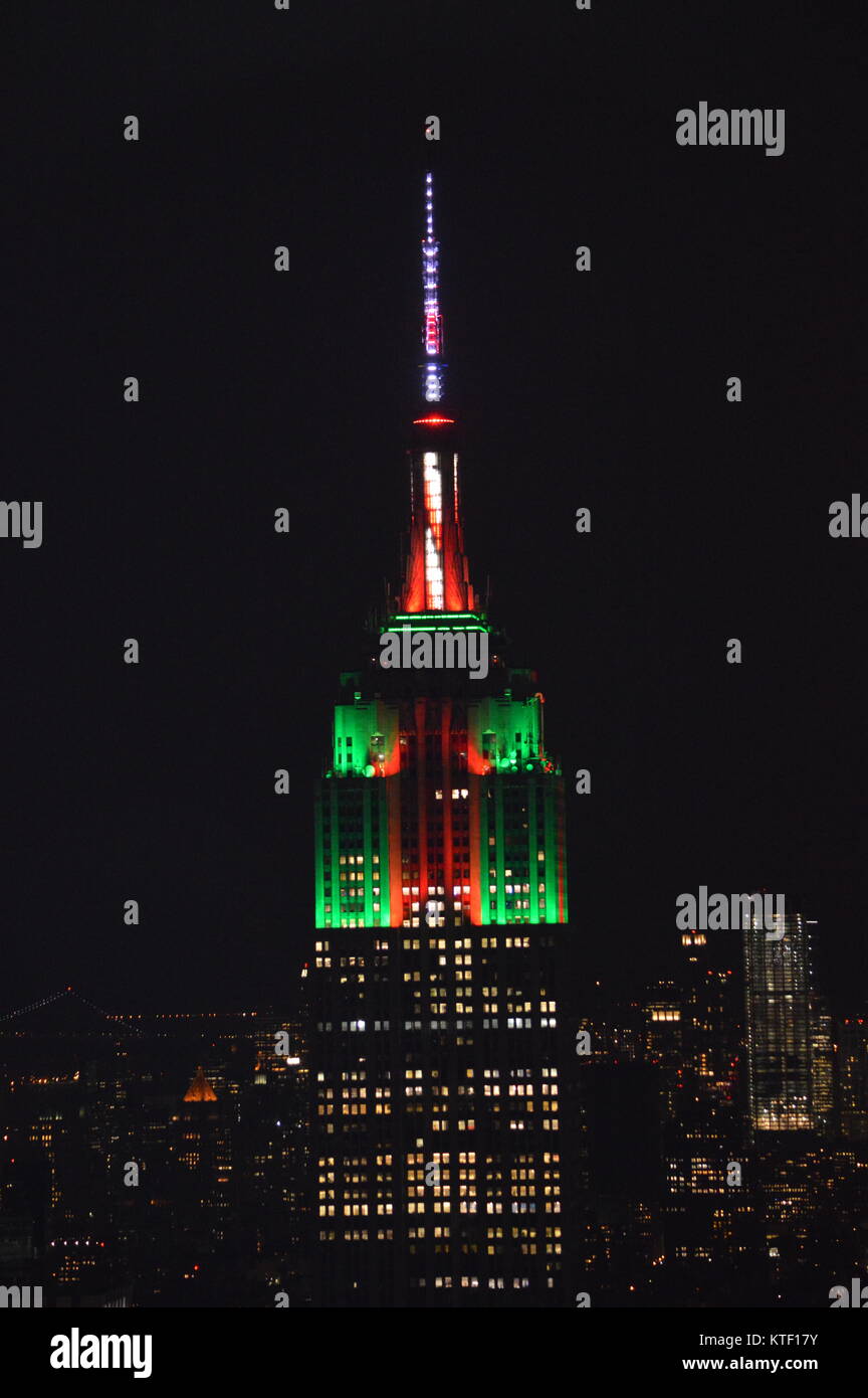 New York, USA. 23 Dez, 2017. Der Blick auf das Empire State Building bis leuchtet grün und rot mit Zuckerstange Antenne in der Feier von Weihnachten. Stockfoto