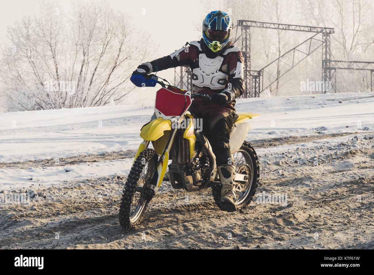 Motorradfahrer Schutzkleidung Enduro in den schmutzigen Schnee auf einem motocross Track im Winter. Extremen Motorsports. Racer geht. extreme off road Spaß in Win Stockfoto