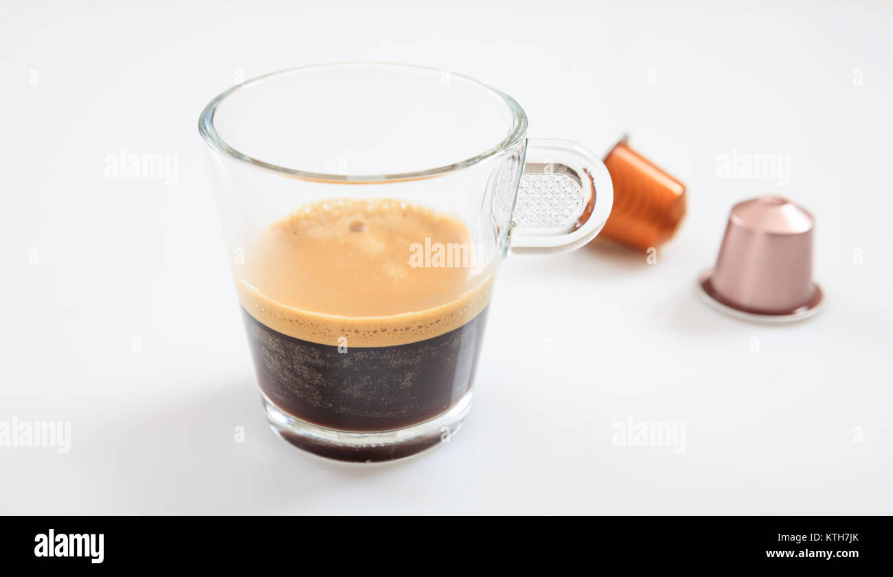 Tasse Espresso und Kaffee Kapseln, auf weißem Hintergrund, Detailansicht mit Details Stockfoto