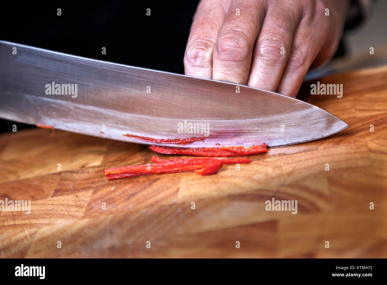 Die Zubereitung der Salamitaktik roter Chili auf Schneidebrett Stockfoto