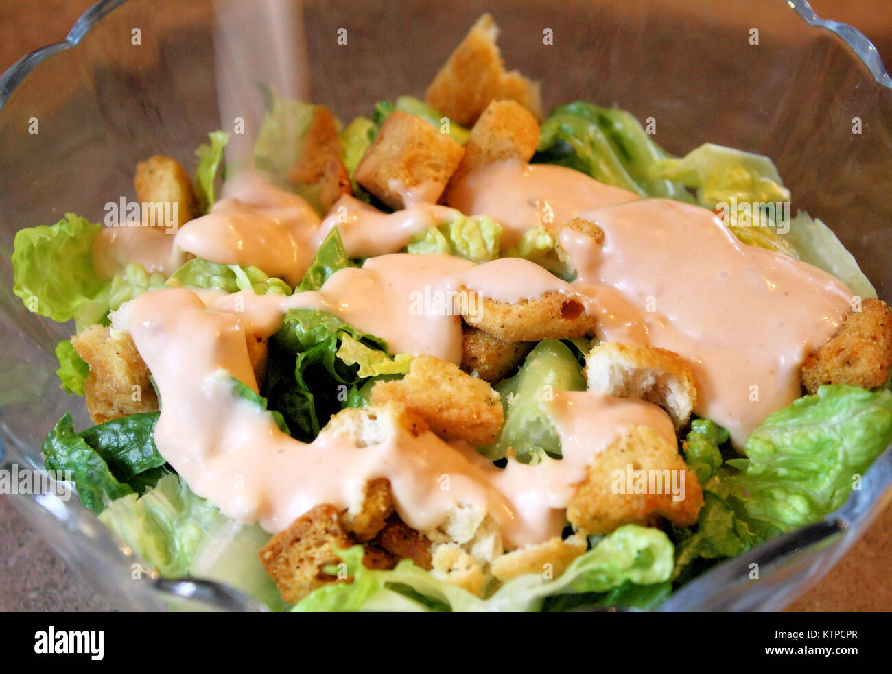 Gartensalat mit Salatsoße geschüttet wurde und Croutons Stockfoto