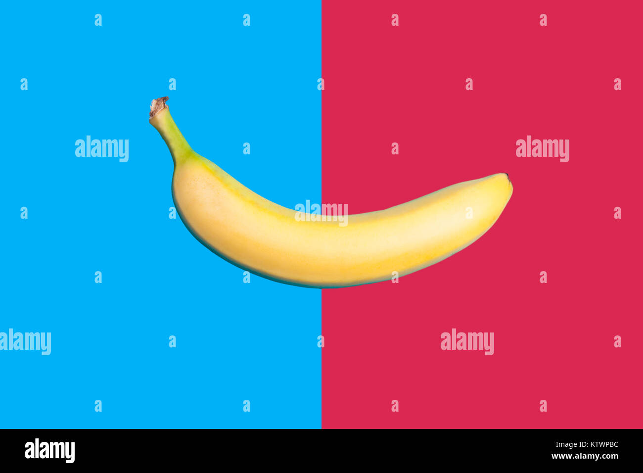 Banane auf zwei farbigen bacground in der Mitte geteilt Stockfoto