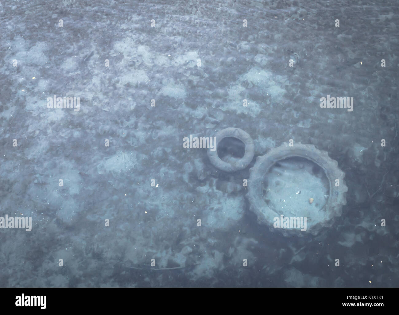 Seichten Fluss mit Reifen unter Wasser verschmutzt. Umweltproblem. Stockfoto