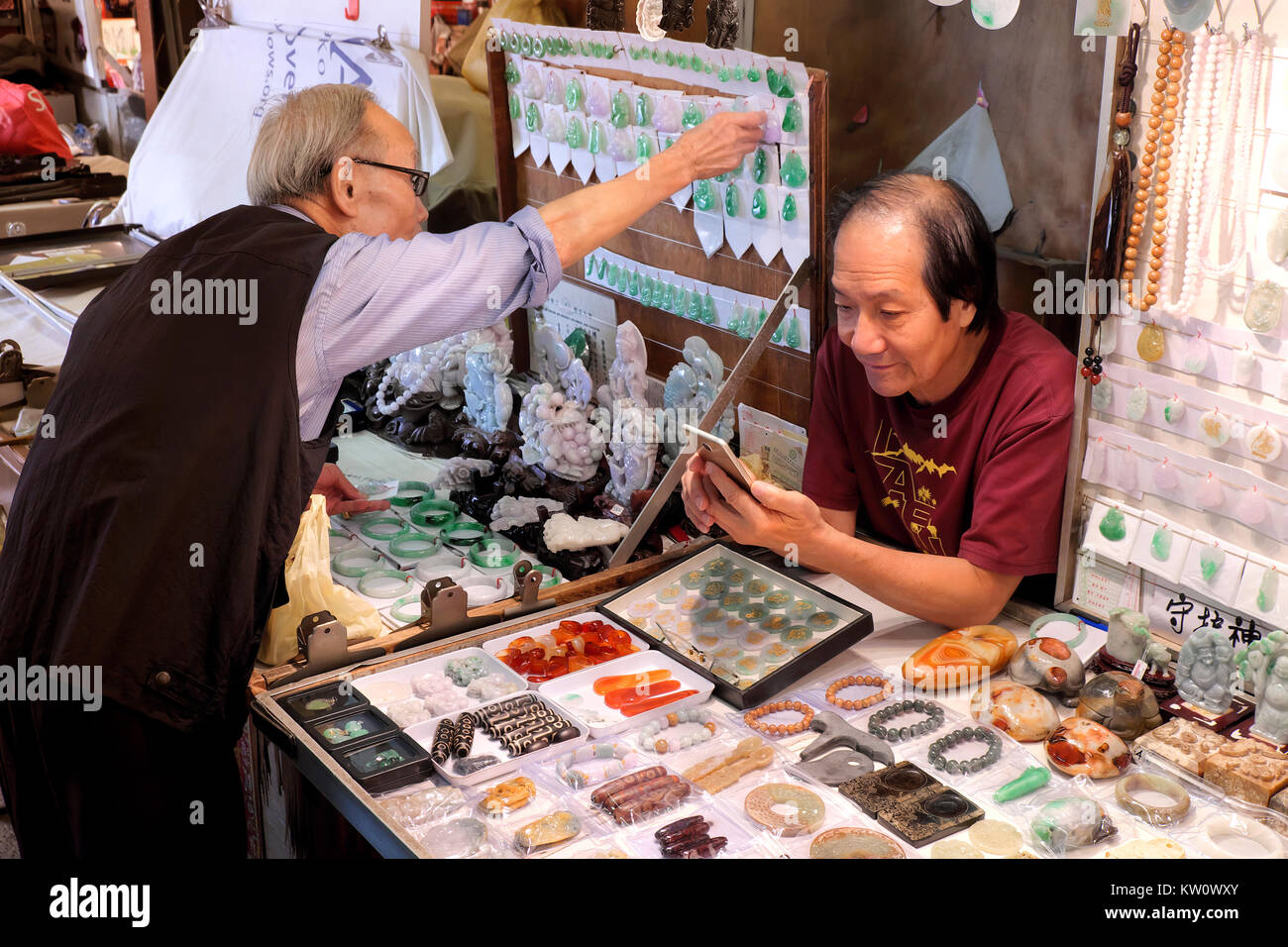 Jade Händler prüfen sein Smartphone, Jade Markt, Yau Ma Tei, Kowloon, Hongkong, China Stockfoto