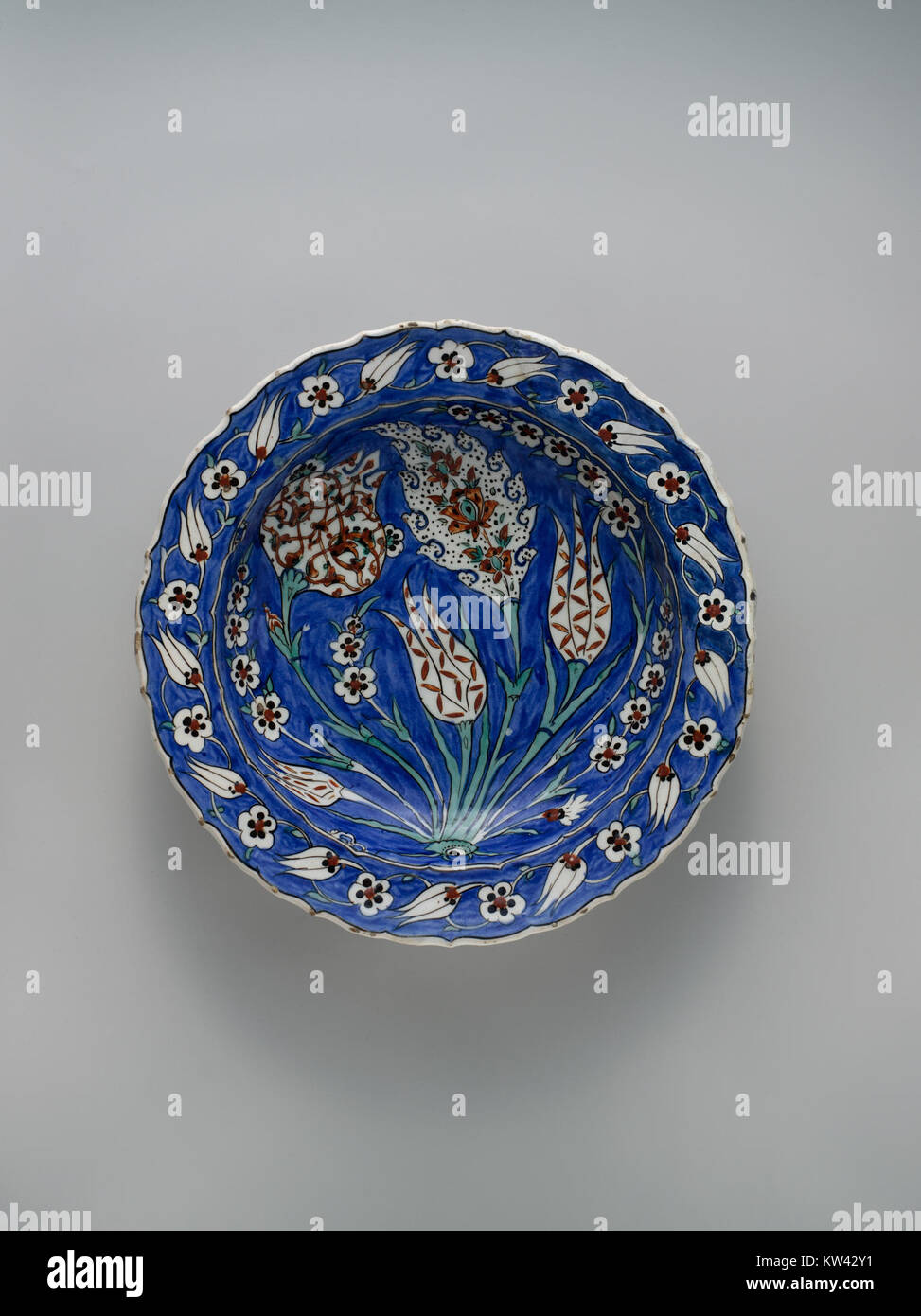 Diese blau gemahlene Schale mit Blumenmuster ist ein dekoratives Kunstwerk aus der MET-Kollektion. Es zeigt komplexe Handwerkskunst und ein traditionelles Blumenmotiv auf blauem Hintergrund, das kulturelle Kunstpraktiken widerspiegelt. Stockfoto