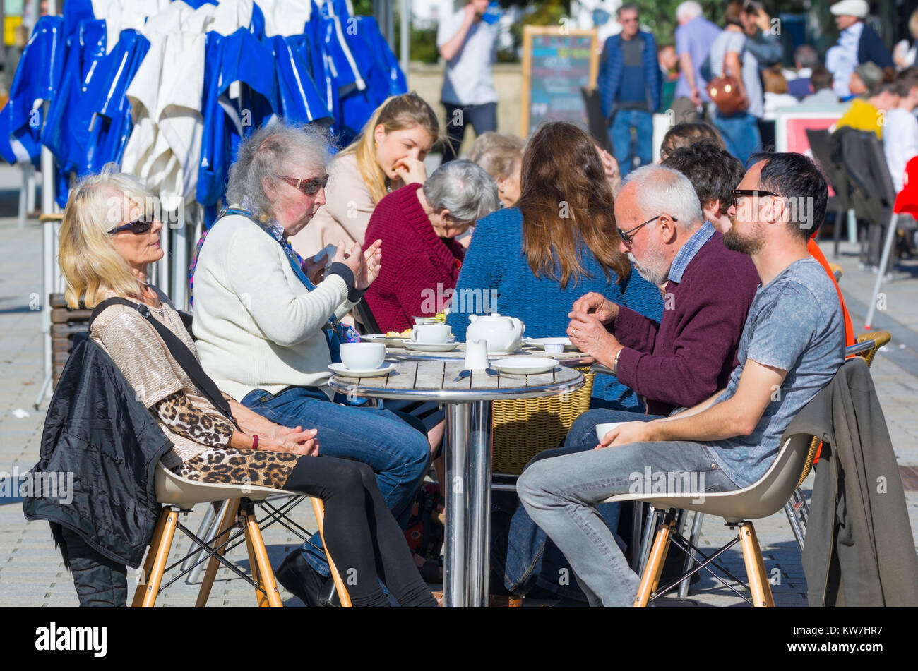 Freunde an Tischen im Freien in einem Café sitzen, Kaffee trinken im Sommer in Großbritannien. Stockfoto