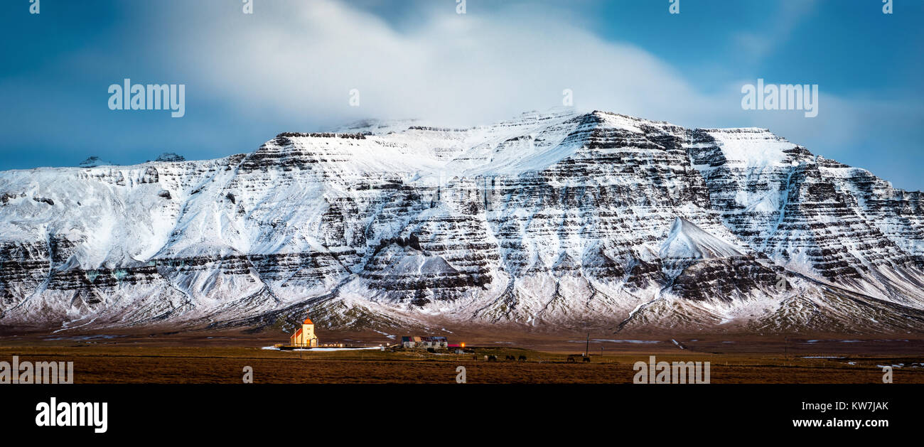 Kleinen isländischen Kirche unter schneebedeckten Bergkette von Snaefellsnesvegur Trollakirkja Autobahn gesehen, im Westen von Island Stockfoto