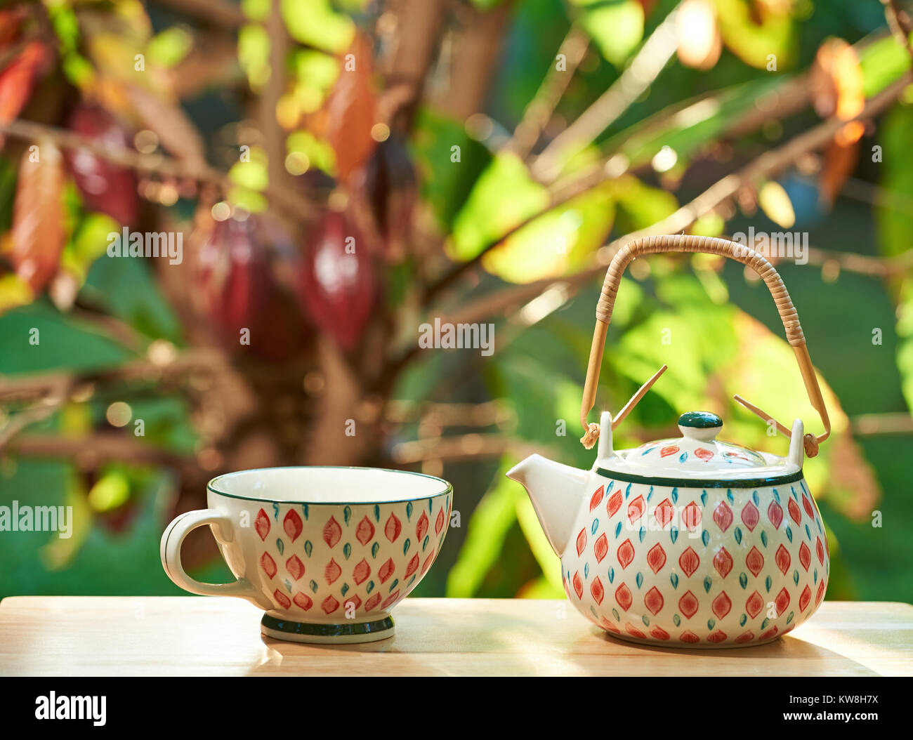 Bunte Kaffee Tasse mit Topf auf Holztisch mit blur Bokeh organische Baum-ernte Hintergrund Stockfoto