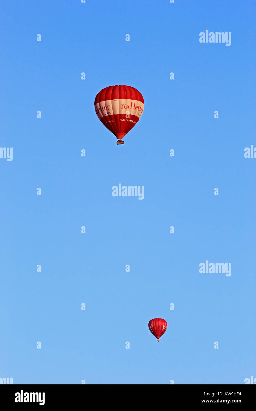 Red Letter Days Heißluftballon, mit Virgin Ballon hinter, gegen ein strahlend blauer Himmel, Fliegen, Somerset Stockfoto