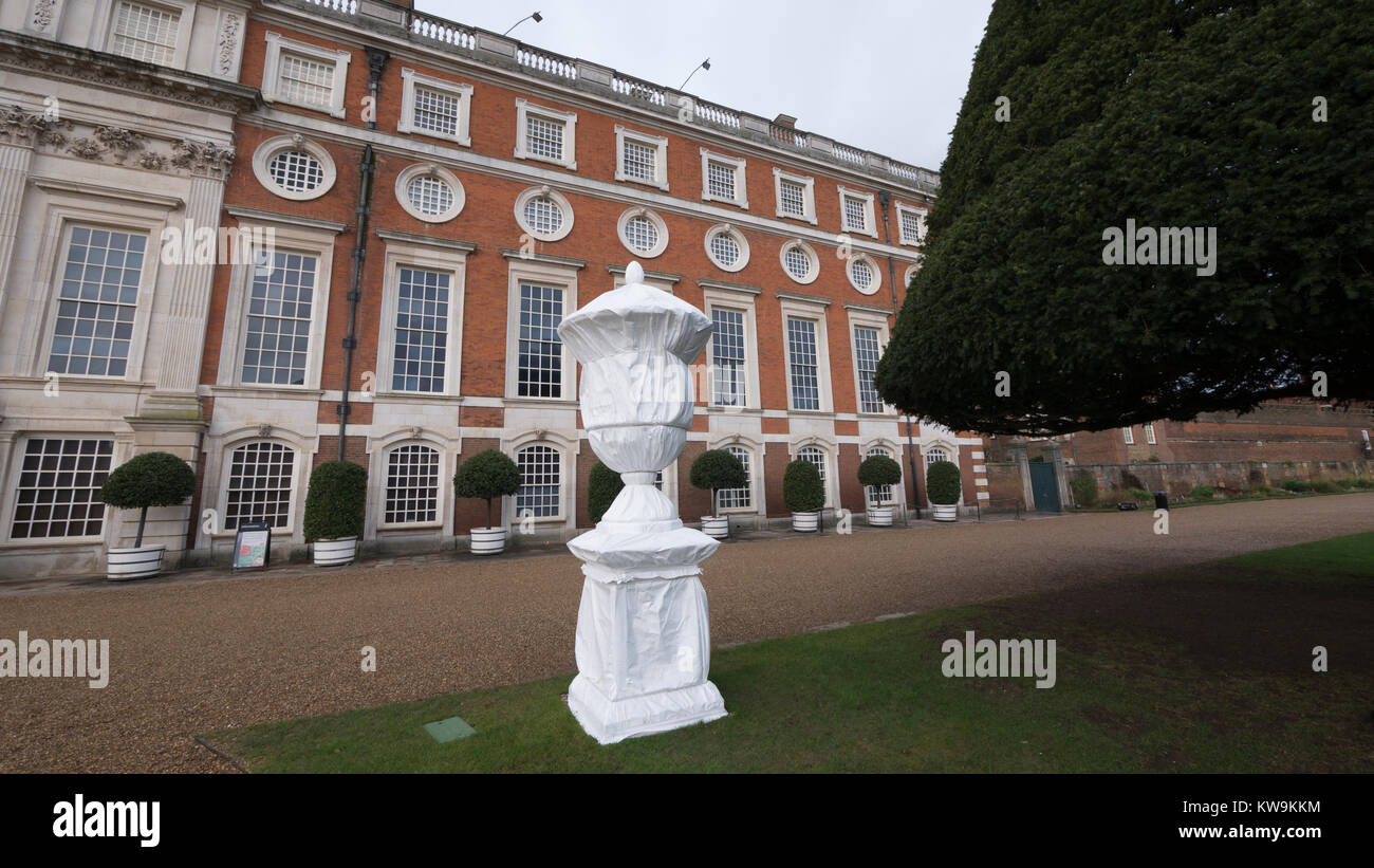 Steinerne Statue in Kunststoff winter Schutzhülle mit Baum Formgehölze in Hampton Court Palace abgedeckt Stockfoto