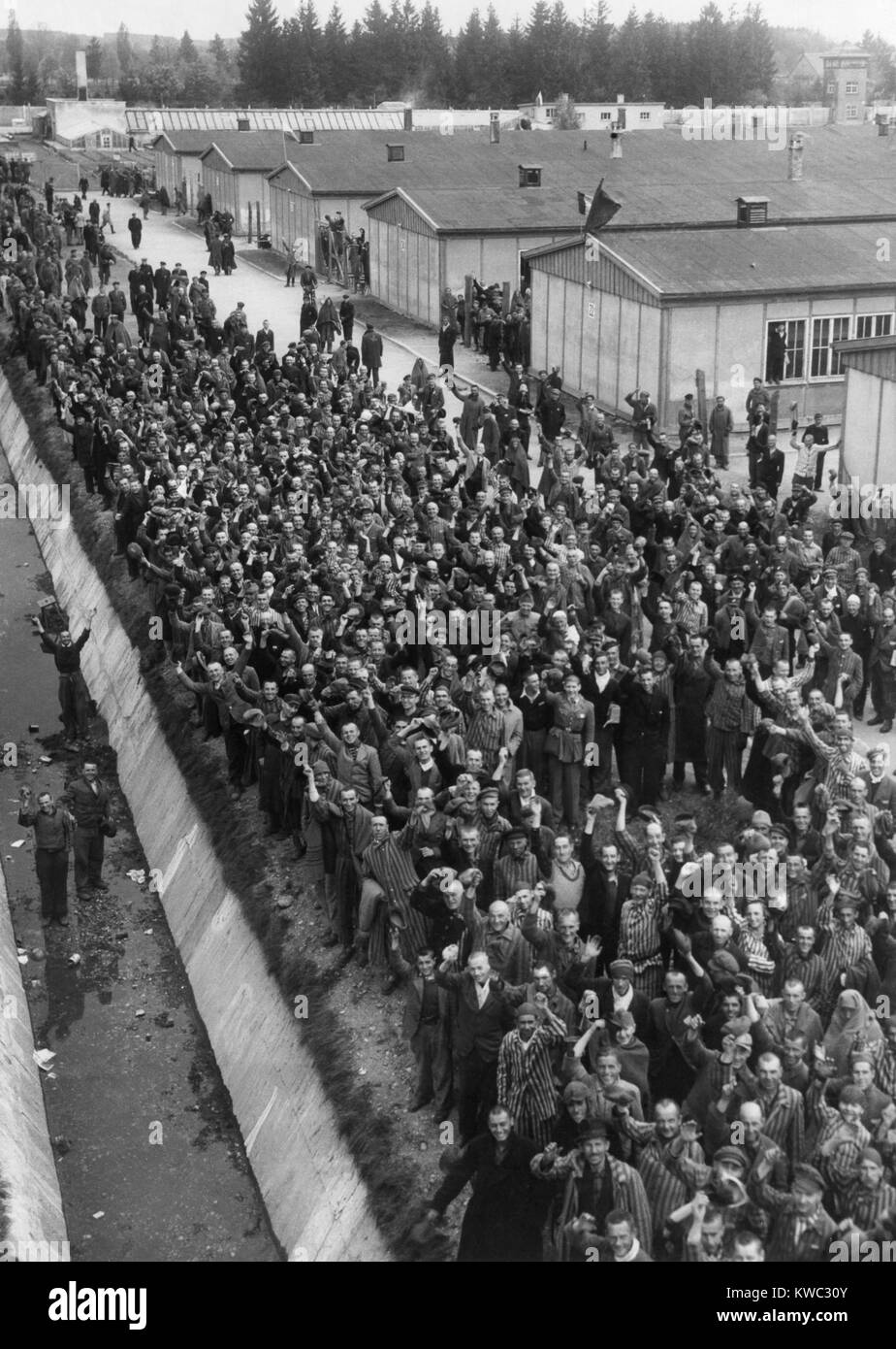 Häftlinge in Dachau rufen eine Grußansage zu befreienden Soldaten der 42th Division der Siebten US-Armee. Sie Masse zwischen der Kaserne und dem Rand des Grabens, die Rans entlang dem Zaun des Lagers. April 29, 1945, 2.Weltkrieg (BSLOC 2015 13 17) Stockfoto